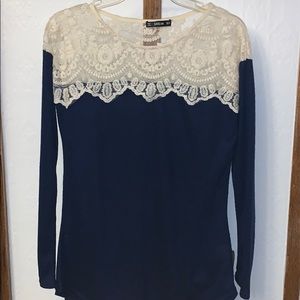A BLUE LONG SLEEVE, with white lace on the top
